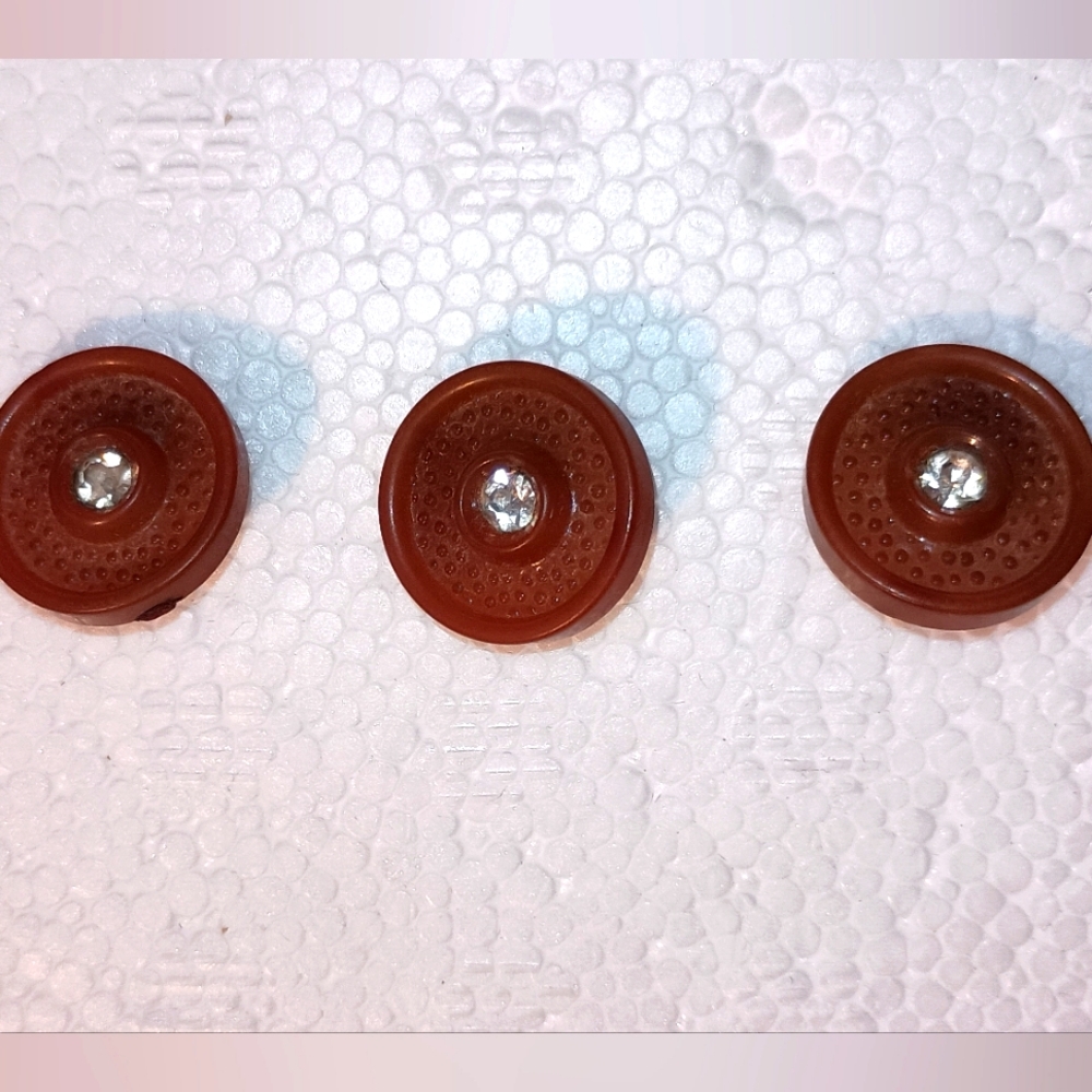 Vintage Brown plastic buttons with fake diamond like stone in center.